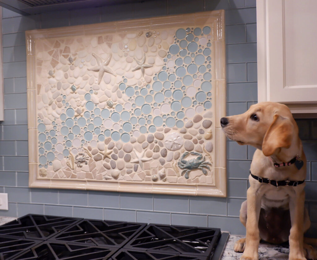 kitchen mosaic tile mural backsplash with dog sat on the counter next to it